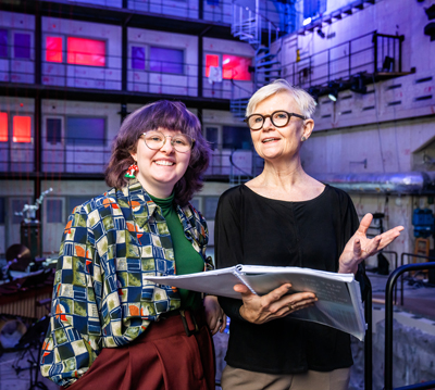 Åsa Unander-Scharin (th) läser ur partituret och Elsa Benzinger ler.
